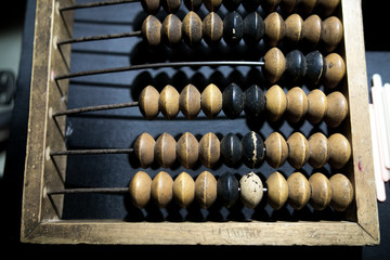 Obsolete wooden abacus, black background