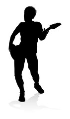 A guitarist musician in detailed silhouette playing his guitar musical instrument.