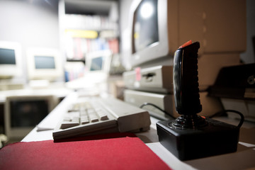 Close up on a joystick with a blurred background in an arcade hall