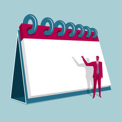 Businessman in front of a huge calendar. Isolated on blue background.