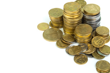 Gold towers made out of gold and silvery of Ukraine coins, stack isolated on white.