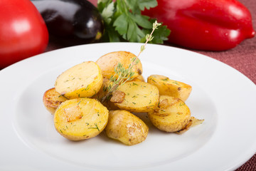 Baked yellow potatoes as garnish served with thyme