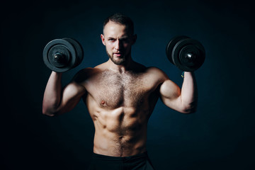 Fototapeta na wymiar Strong sport sirtless man making weightlifting with dumbbells