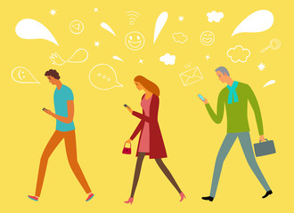 People walking and  looking on their phones.