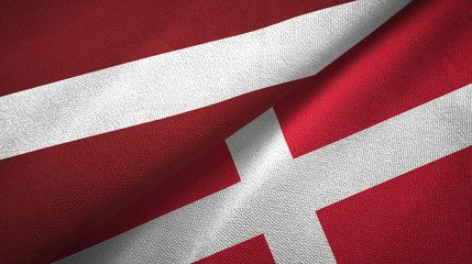 Latvia and Denmark two flags textile cloth, fabric texture