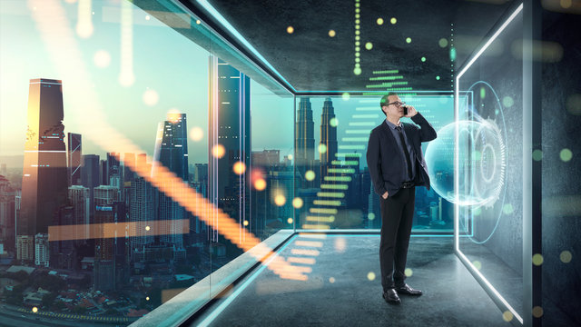 Businessman in suit working with virtual 3d holographic interface screens . Futuristic business, technology, internet and social networking technology concept ..