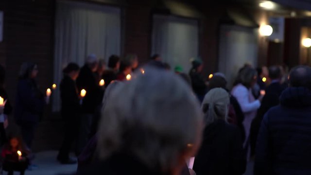 group of people gathering together at candle vigil