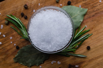 Round glass bowl with sea salt.