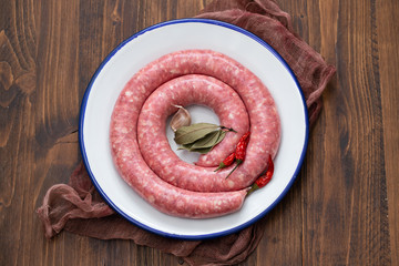 typical spanish sausage on white dish on wooden background