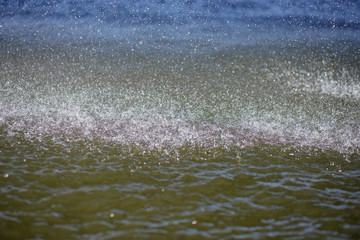 splashes of the water flowing from the fountain to the river