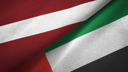 Fototapeta na wymiar Latvia and United Arab Emirates two flags textile cloth, fabric texture