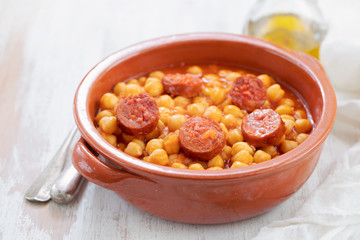 chick pea with smoked sausage in ceramic dish