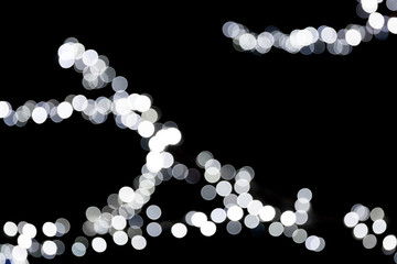 Abstract bokeh of white city lights on black background. defocused and blurred many round light