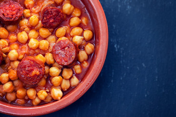 chick pea with smoked sausage in ceramic dish