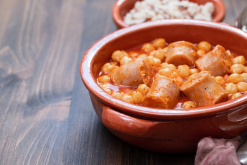 spanish sausage with chick-pea in ceramic dish