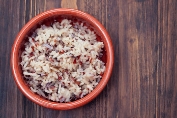 boiled healthy rice in brown ceramic pot