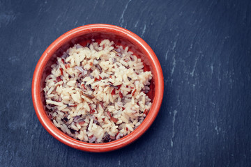 boiled healthy rice in brown ceramic pot