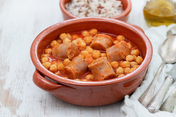 chick-pea with sausage in ceramic pot