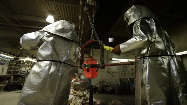hot bronze being poured in foundry