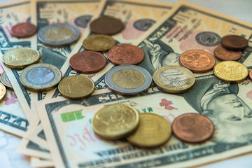 Euro coins of different denominations on the background of dollar bills.Close-up of several euro coins. Concept of trading on the stock exchange. Euro exchange rate