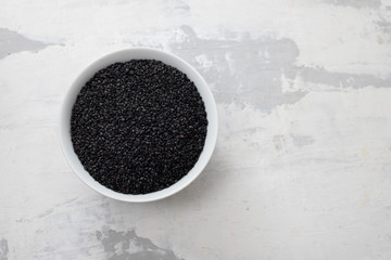 seeds of black sesame in the white bowl