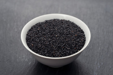seeds of black sesame in the white bowl