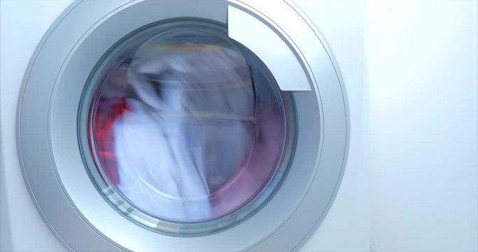 Close Up Industrial Washing Machine Washes Colored Clothing and White Linen, White Striped Clothing. Cylinder Spinning Machine. Concept Laundry Washing Machine, Industry Laundry Service.