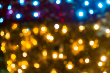 Blurred abstract background of Christmas lights.Brightly glowing yellow-orange balls and lines.Abstract color patterns