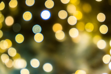 Blurred abstract background of Christmas lights.Brightly glowing yellow-orange balls and lines.Abstract color patterns