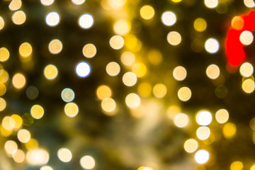 Blurred abstract background of Christmas lights.Brightly glowing yellow-orange balls and lines.Abstract color patterns