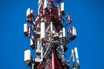A fragment of a cell tower close-up against the blue sky.Modern telecommunication equipment.4G networks