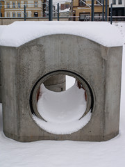 new unused concrete pipe covered in snow