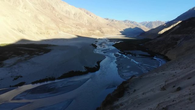 4k aerial fly over river system in dry mountain area in Ladakh in India