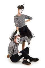 Smiling mimes in striped shirts. Man and woman dressed as actors of pantomime theater isolated on...