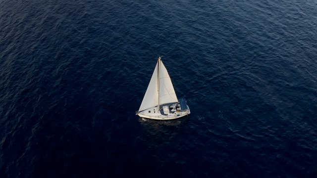 Yacht sailing on opened sea. Flight Around Sail and Ship. Sailing boat. Yachting Aerial 4k video. Yacht from above. Sailboat from drone. Sailing video. Yachting at windy day.
