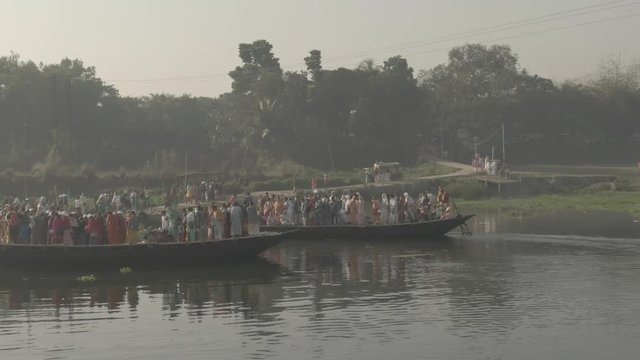 Hare Krishna pilgrims procession in a boat, Mayapur, India, 4k aerial ungraded