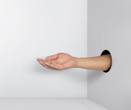 Outstretched hand gesture, holding, asking or offering something, coming out from a hole of paper.