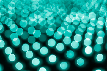 Fototapeta premium Abstract bokeh background. Soft defocused lights. Neon basic cyan color