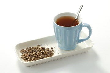 Dried Wood avens - herb Bennet (Geum urbanum) and tea in cup