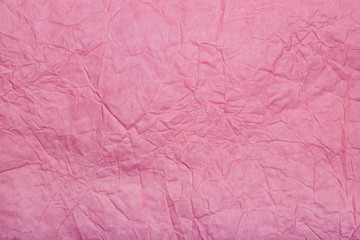 Abstract textured paper pink color background.