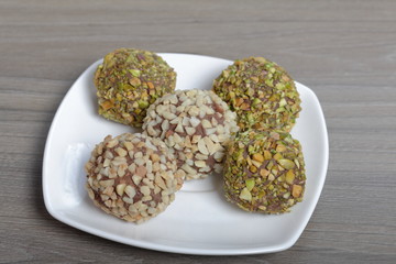 Homemade sweets. Chocolate truffles with a crumb of peanuts and pistachios.