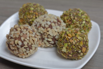 Homemade sweets. Chocolate truffles with a crumb of peanuts and pistachios.