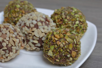 Homemade sweets. Chocolate truffles with a crumb of peanuts and pistachios.
