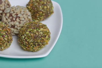 Homemade sweets. Chocolate truffles with a crumb of peanuts and pistachios.