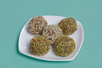 Homemade sweets. Chocolate truffles with a crumb of peanuts and pistachios.