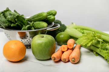 tasty and sweet fruits near ripe and fresh vegetables on grey
