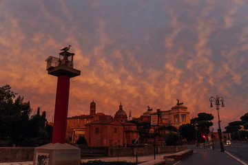Fototapeta na wymiar Red sunrise, beautiful landscape, the main street of Rome, three horses on the roof of the Altar of the Fatherland | ROME, ITALY - 12 SEPTEMBER 2018.