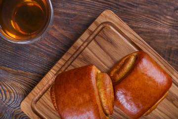 Sweet soft buns with tea. Puff bun with cherry jam. Bakery, top view