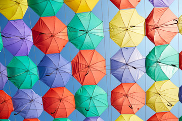 Fototapeta na wymiar The image of colorful umbrellas on a background of blue sky