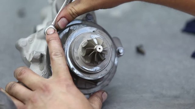 workers hands car turbine repair